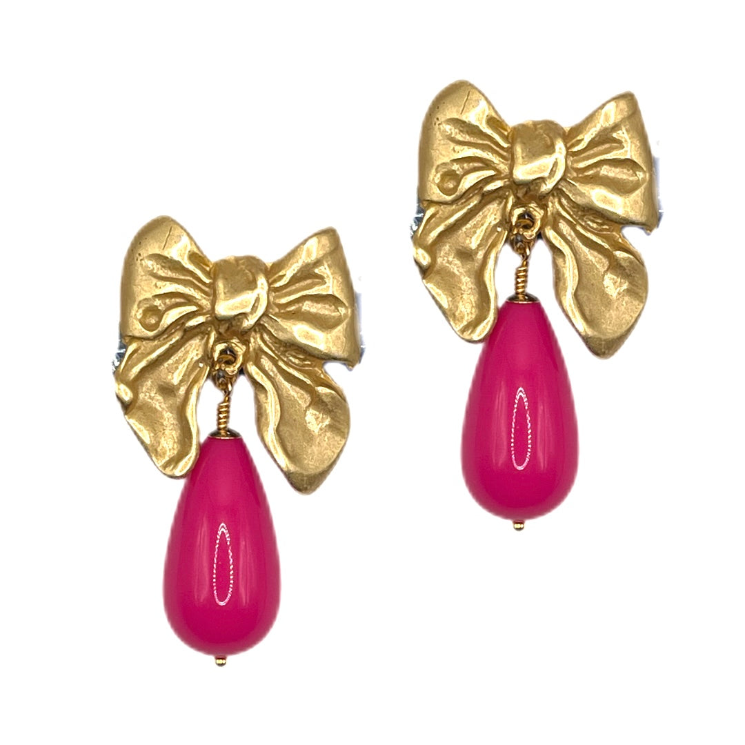 Goldene Schleife mit pink farbigen Tropfen